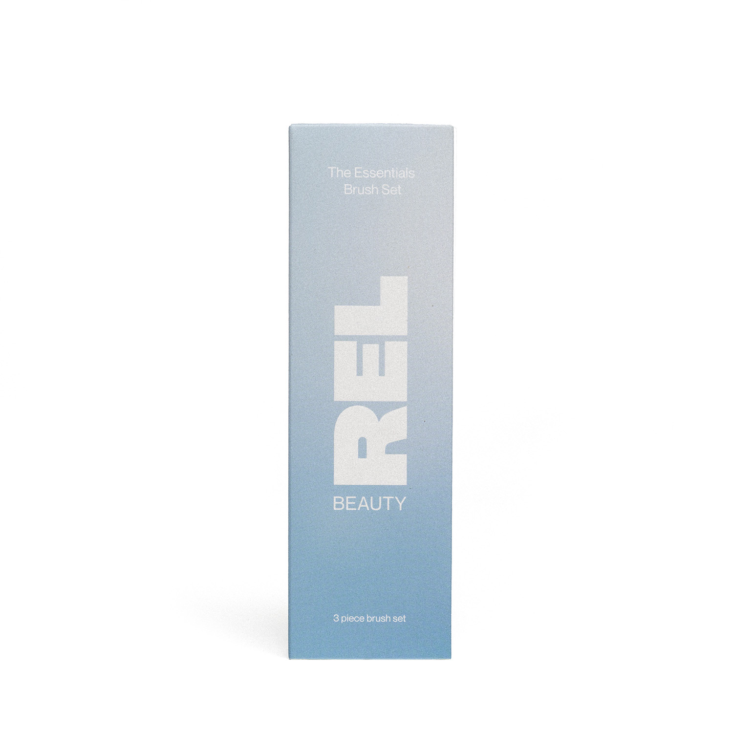 A tall, narrow light blue product box for REL BEAUTY 'The Essentials Brush Set' on a clean white background.